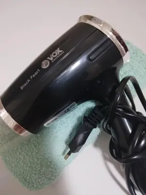 a hair dryer sitting on top of a towel at Green Apartman in Paraćin