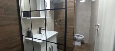 a small bathroom with a toilet and a sink at Holiday apartament three in Niš