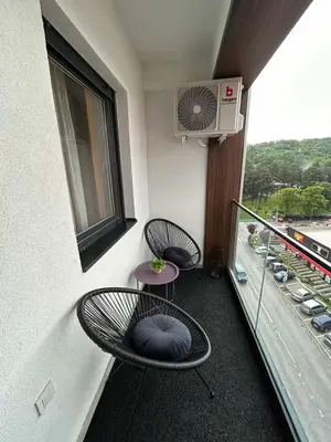 two chairs and a table on a balcony at Matic Apartmani 4 in Trnava
