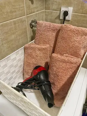 a hair dryer and towels in a bath tub at Apartman Damjan Sokobanja in Soko Banja