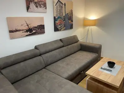 a living room with a couch and a table at luxury Pool Apartment Jagodina in Jagodina