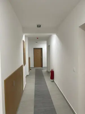 an empty hallway with a hallway with a red suitcase at luxury Pool Apartment Jagodina in Jagodina