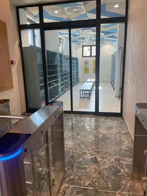 an empty room with a lobby with glass doors and a hallway at luxury Pool Apartment Jagodina in Jagodina