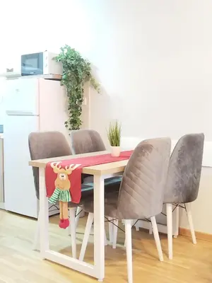 a dining room table with a reindeer pillow on it at SPA 25 in Vrnjačka Banja