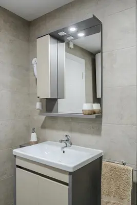 a bathroom with a white sink and a mirror at SPA 25 in Vrnjačka Banja
