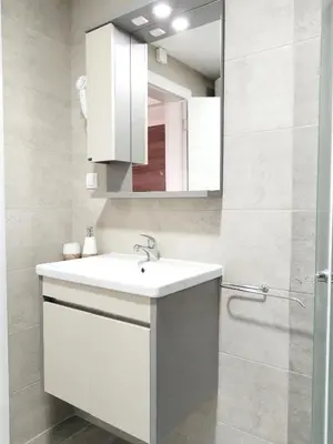 a bathroom with a white sink and a mirror at SPA 25 in Vrnjačka Banja