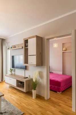 a bedroom with a pink bed in a room at SPA 25 in Vrnjačka Banja