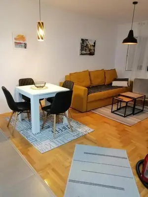 a living room with a table and a couch at City Center Condo Vranje in Vranje