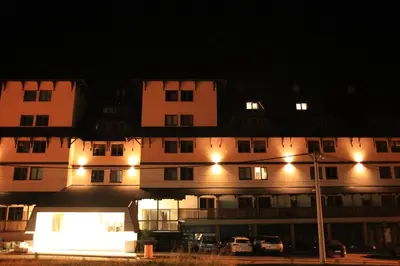 a large building with lights in front of it at night at Apartman Mist - Bela Reka Kopaonik in Brzeće