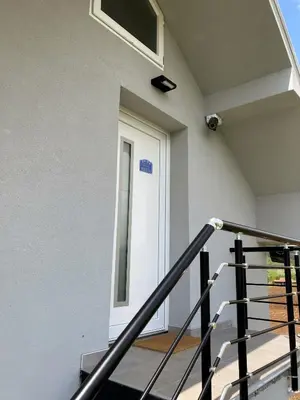 a door in a white building with a window at Agro Lux Apartment - Milenović in Soko Banja