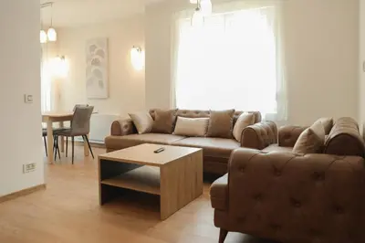 a living room with a couch and a table at GOLDEN VIEW Sokobanja in Soko Banja