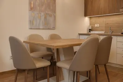 a kitchen with a wooden table and chairs at GOLDEN VIEW Sokobanja in Soko Banja