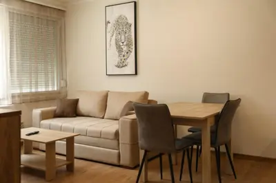 a living room with a couch and a table at GOLDEN VIEW Sokobanja in Soko Banja