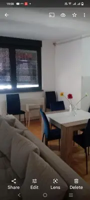 a living room with a couch and a table at Riviera Apartments in Niš