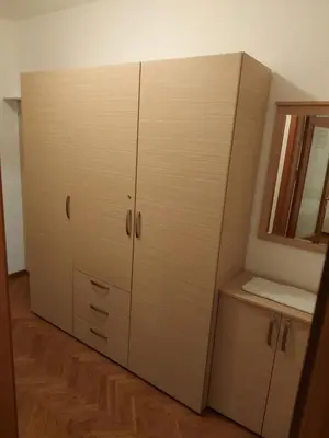 a large white cabinet in a room with a mirror at Apartman Sneznik in Vrnjačka Banja
