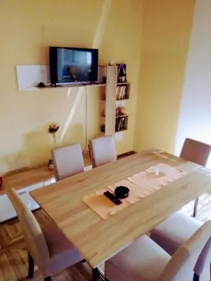 a dining room with a wooden table and chairs at Timočko gnezdo in Zaječar