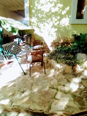 a patio with two chairs and a table at Timočko gnezdo in Zaječar