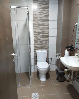 a bathroom with a toilet and a sink at Garden Hill Apartment in Jagodina