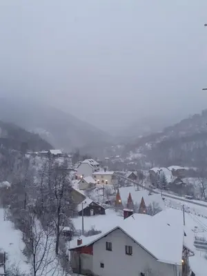 a small town covered in snow with buildings at STD Cvetković in Crni Vrh