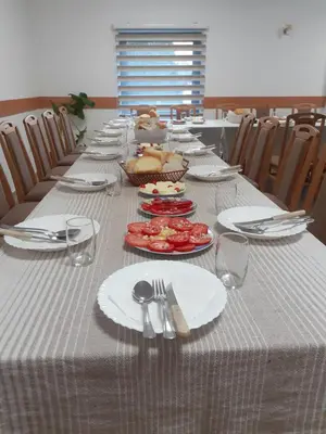 a long table with plates and utensils on it at STD Cvetković in Crni Vrh
