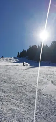 a field covered in snow with the sun in the background at STD Cvetković in Crni Vrh