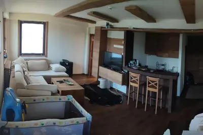 a living room with a couch and a table at Vidik suite in Kopaonik