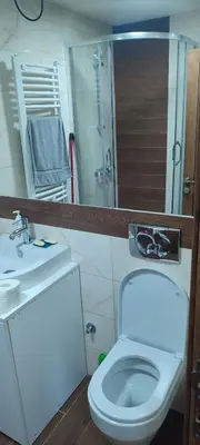a bathroom with a toilet and a sink and a mirror at Vidik suite in Kopaonik