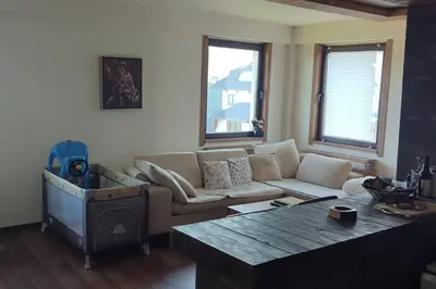 a living room with a couch and a table at Vidik suite in Kopaonik