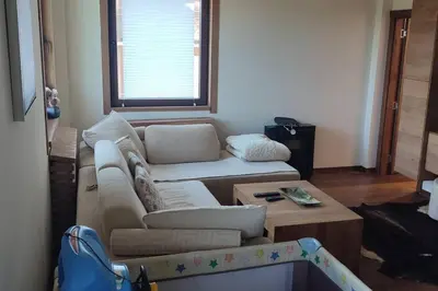 a living room with a couch and a coffee table at Vidik suite in Kopaonik