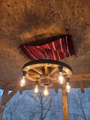 a chandelier hanging from a ceiling with a flag at Kmetova Bajka in Janja