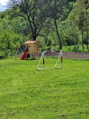 a park with a swing set and a playground at Kmetova Bajka in Janja