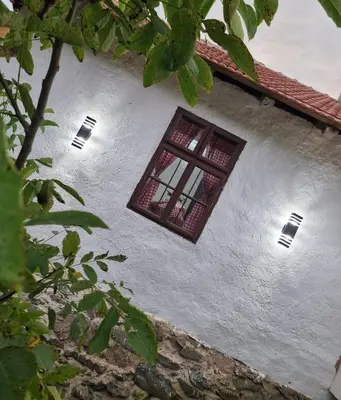 a window on the side of a white building at Kmetova Bajka in Janja