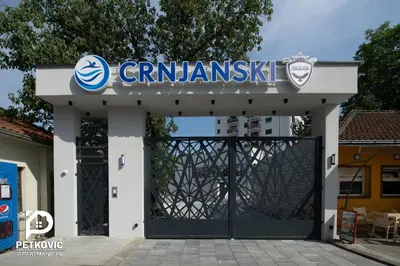 a garage with a sign on top of it at Petković apartmani 35 in Jagodina