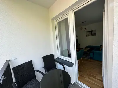 a room with two chairs and a table and a window at Apartman Pavlović in Soko Banja