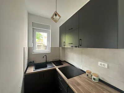 a kitchen with a sink and a window at Apartman Pavlović in Soko Banja