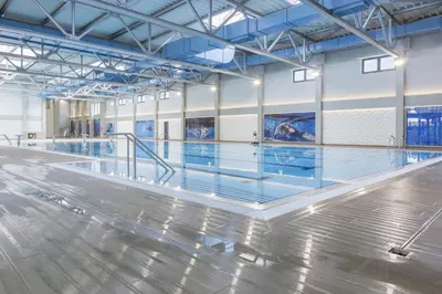 an empty swimming pool with ailed floor and blue ceilings at Lux Apartman Petrovic in Jagodina