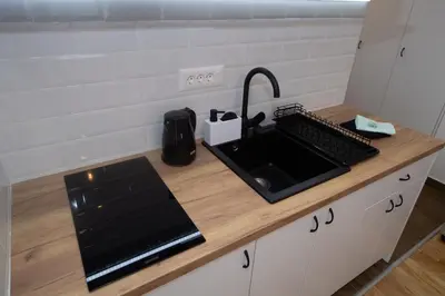 a kitchen counter with a sink and a keyboard at Lux Apartman Petrovic in Jagodina