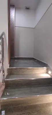 a set of wooden stairs in a room at Apartmani Simić in Kuršumlija