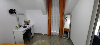 a small bathroom with a sink and a mirror at Apartmani Simić in Kuršumlija