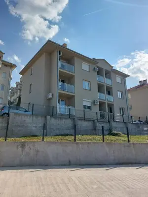 a apartment building with a fence in front of it at Apartment Vojinović in Soko Banja