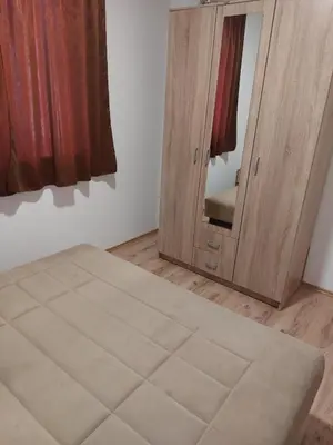 a room with a mirror and a wooden door at Apartment Vojinović in Soko Banja