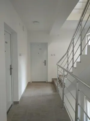 a hallway with stairs and a door in a building at Apartment Vojinović in Soko Banja