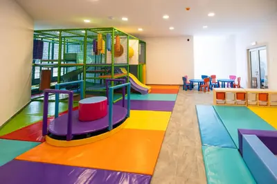 a brightly colored play room with a slide at Planinka in Kursumlijska Banja