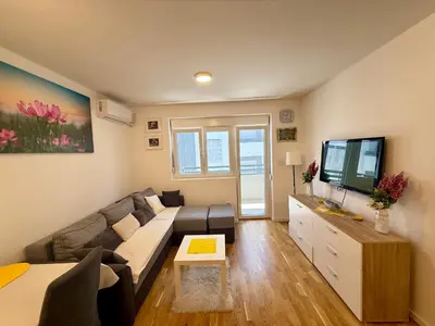 a living room with a couch and a flat screen tv at Mirabela Apartman Sokobanja in Soko Banja
