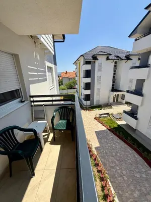 a balcony with two chairs and a table on a building at Mirabela Apartman Sokobanja in Soko Banja