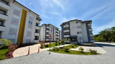 a car parked in a parking lot next to buildings at Mirabela Apartman Sokobanja in Soko Banja