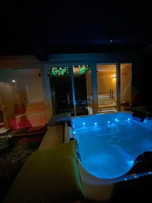a jacuzzi tub in a living room at night at Villa Prive and Spa in Kopaonik