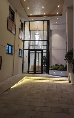 an empty room with a large glass window in a building at Orca Apartman in Jagodina