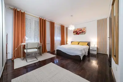 a bedroom with a bed and a desk and a chair at Nana in Pirot