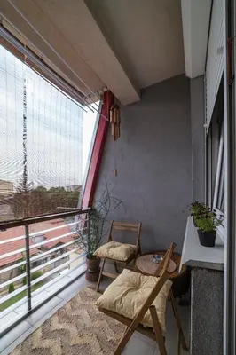 a balcony with two chairs and a table and a window at Nana in Pirot